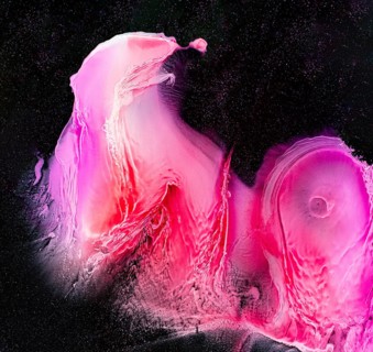 This vivid abstract artwork showcases swirling pink and red hues against a rich black backdrop,