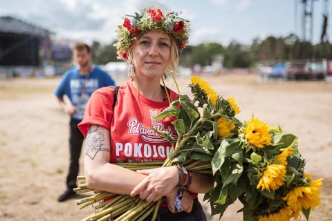 KOSTRZYN NAD ODRA, POLAND - AUGUST 1, 2019: Woman from Peaceful patrol with sunflowers in the