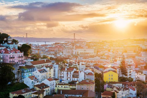 Beautiful view of Lisbon at sunset from Miradouro da Senhora do Monte, showcasing the cityscape and