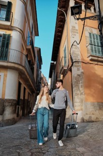 A young couple wanders through charming streets, searching for their perfect vacation home in
