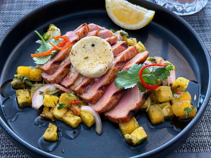 Succulent grilled pork steak topped with a poached egg, served with a spicy Thai-style pineapple