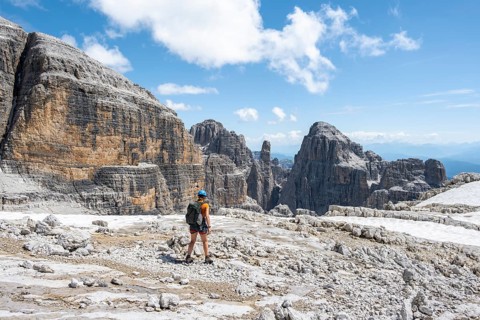 Hikers on the Sentiero Brentari hiking trail in front of cliffs, Brenta Mountains, Brenta-Adamello