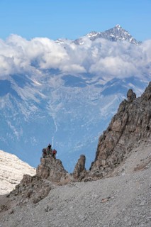 View through a flock of Cima Presanella, hikers on the Via Ferrate Benini via ferrata, Brenta