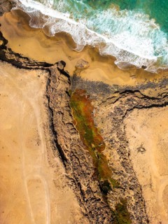 From above, the untouched natural landscape of Tindaya Beach in Fuerteventura, Canary Islands,