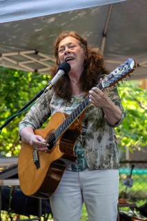 Southfield, Michigan, Claudia Schmidt sings at a backyard concert