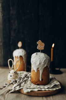 Kulich, a traditional Russian Easter bread, adorned with icing and playful gingerbread cookie