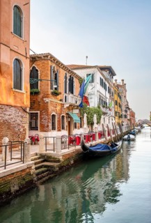 Venetian gondolas and colourful house facades on a small canal, Venice, Veneto, Italy