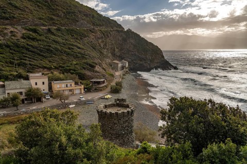 Beach and Genoese tower of La Marine de Negru on the west coast of Cap Corse, Corsica, France