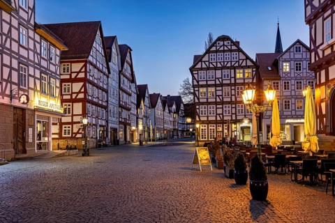 Atmospheric square with illuminated half-timbered houses at dusk, The old town centre of Melsungen
