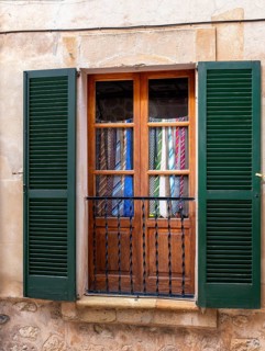 Windows in which old ties serve as curtains, Valdemossa, Majorca, Spain