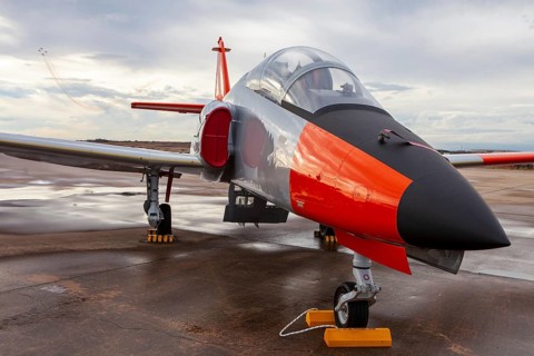 A vibrant military jet at Torrejon Air Base in Spain, an impressive part of an air show exhibition.