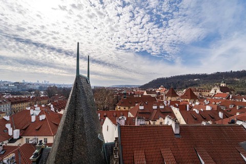 Captivating aerial shot showcasing the bustling rooftops of Prague, highlighted by a scenic