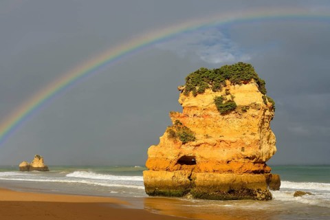 Rocks on beach with rainbow, Praia Dona Ana, Lagos, Algarve, Portugal
