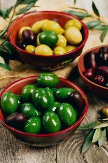 A mixture of olives, varieties of chalkidiki, Verdi giganti and Kalamata, in a bowl, top view, no