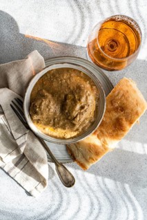 Top view of an iconic Georgian dish, satsivi, featuring rich walnut sauce and tender chicken,