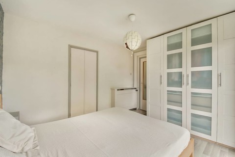 A sleek, modern bedroom showcasing minimalistic design with a clean aesthetic and stylish