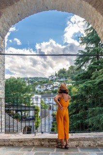 A tourist woman looking at the city of Gjirokaster or Gjirokastra. Albanian