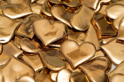 An array of golden, heart-shaped objects symbolizing love and affection, ideal for Valentine's Day