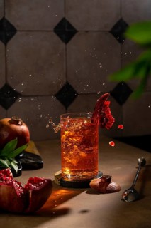 A crisp image of a refreshing pomegranate drink with a splash, symbolizing freshness and vigor, set