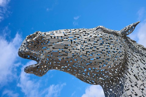 Close-up of an imposing modern metal horse sculpture against a bright blue sky, Ardrishaig, Loch