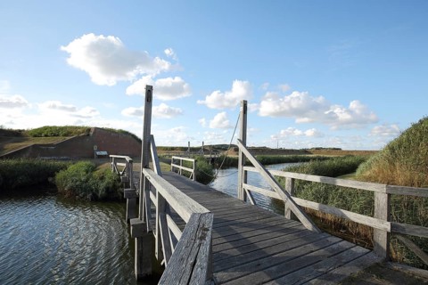 Wooden bridge to historic fortress with moat, Fort de Schans, Texel, North Holland, Holland,