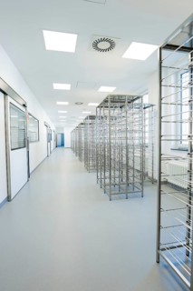 Long corridor with metal shelves in a brightly lit, sterile environment, operating room in the new