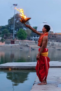 UJJAIN, INDIA, APRIL 23, 2011: Brahmin performing Aarti pooja ceremony on bank of holy river