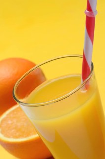 Orange juice in glass and orange, straw