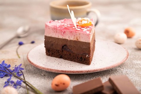 Chocolate cake on brown concrete background, cup of coffee, side view, close up, selective focus