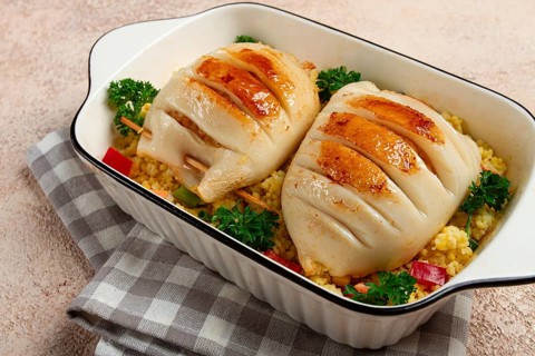 Stuffed squid carcasses, baked in the oven, fried, with couscous, top view, homemade, no people