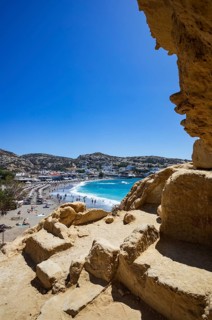 View from the rock caves to the beach of Matala, south coast, Crete, Greece