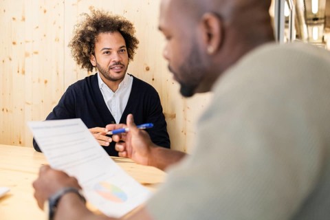 Professionals engage in a productive meeting at a coworking space in Barcelona, fostering