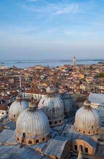 View over the roofs of Venice with the domes of St Mark's Basilica in the evening light, view from