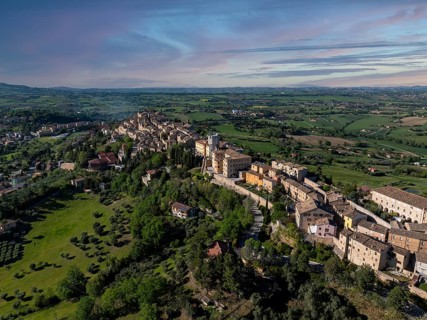 Breathtaking aerial view of Treia, Italy, showcasing historic architecture amid lush greenery and