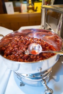 Silver bowl with red fruit and a large serving spoon on a table, Europäischer Hof, Königsbach