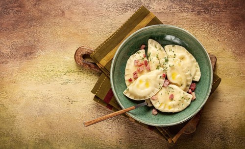 Dumplings, with fried prosciutto, a traditional dish of Polish cuisine, dumplings, top view,