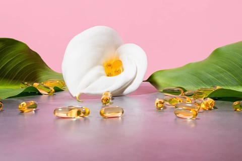 Serene display featuring golden omega-3 oil supplement capsules nestled in a white calla lily,