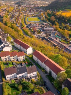 Aerial view of a residential neighbourhood with surrounding sports fields and industry, Nagold,