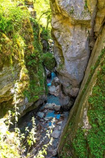 Turquoise water flowing through tolmin gorges in slovenia, creating a picturesque natural landscape