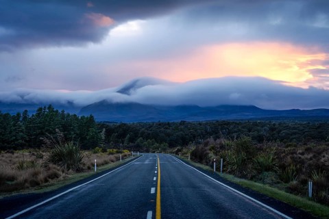 Mount Ngauruhoe in the morning at sunrise with glowing clouds, road SH 47. Tongariro National Park,
