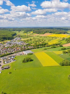 Spacious landscape with village and fields under a blue sky with clouds, Gechingen, Black Forest,