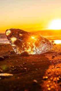 Beautiful sunrise with ice on Diamond Beach next to Jokulsarlon in winter in Iceland