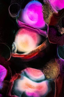 An abstract image showcasing vibrant, swirling liquid patterns in bold colors like pink, purple,