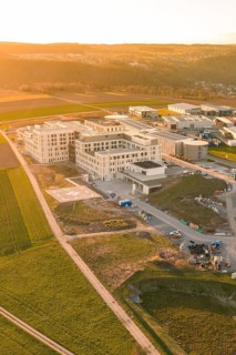 Detailed aerial view of a new building in an agricultural landscape at sunset, new hospital at the