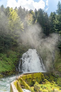 Stunning waterfall in Jaun, Gruyere region, Switzerland, showcasing the Gastlosen mountains. Spring