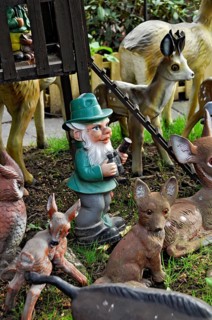 Garden gnomes, foresters with animals in the forest, in a front garden on a flower meadow with