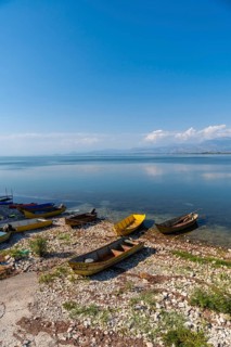 Colorful boats in the beautiful landscape in Shiroka on Lake Shkoder. Albania