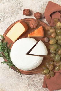 Georgian cheese, Imeretian and smoked suluguni, grapes, nuts, on a cutting board, Georgian cuisine,