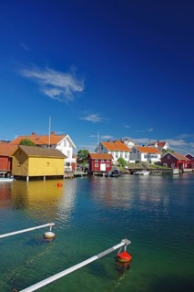 Coastal landscape with colourful wooden houses on an archipelago island by the water under a clear