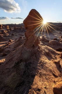Breathtaking view of sandstone formations in Goblin Valley State Park, Utah. The sun sets, casting